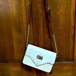 Selling a cream crossbody purse